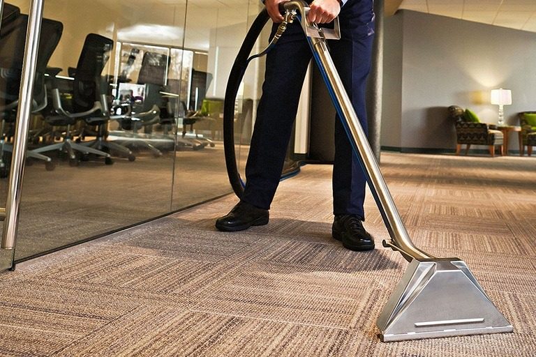 Hot-water extraction cleaning commercial carpet tile in an office